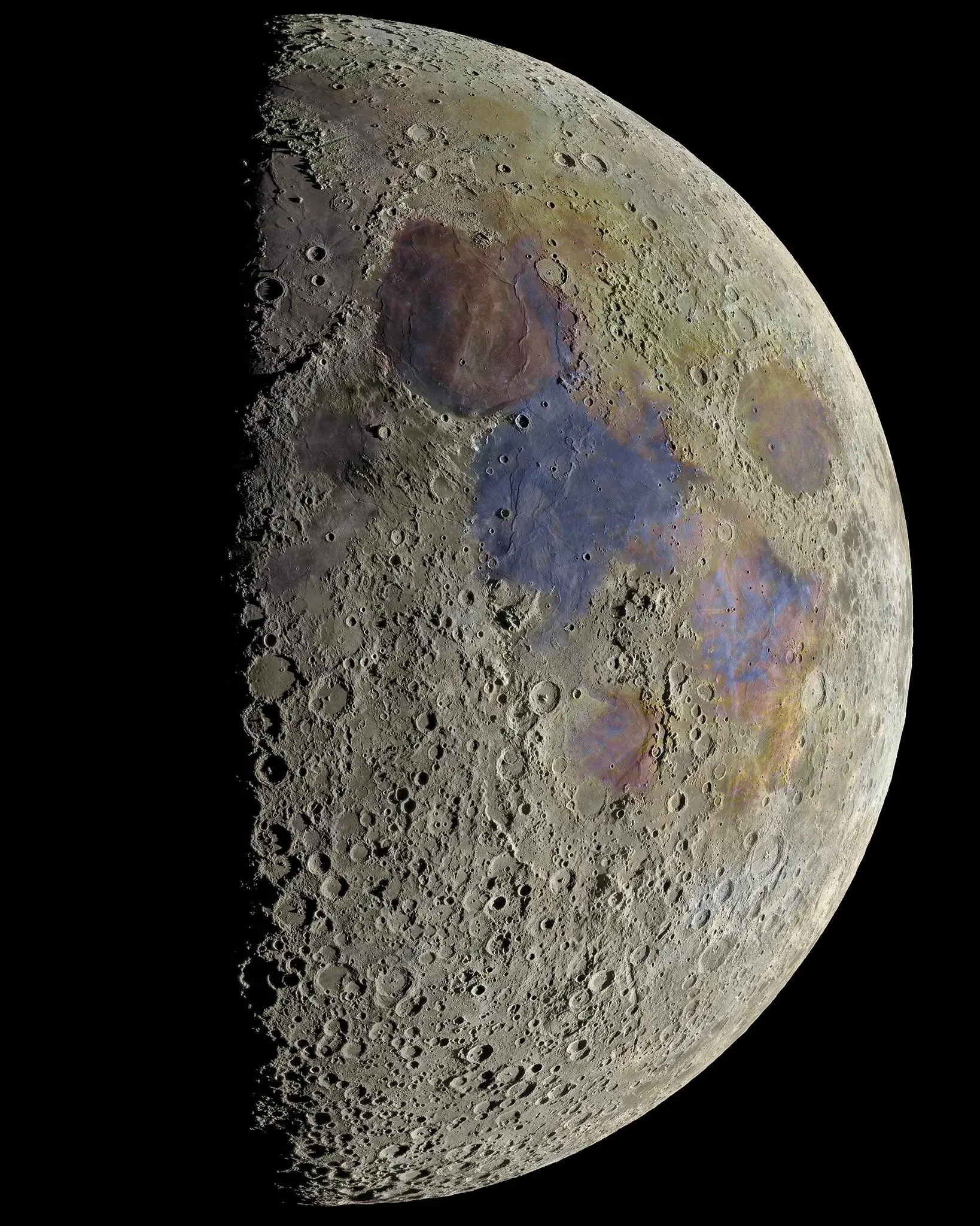 Extremely high res moon photo, with enhanced colours. The surface is pockmarked and traces of different elements are apparent across the surface.